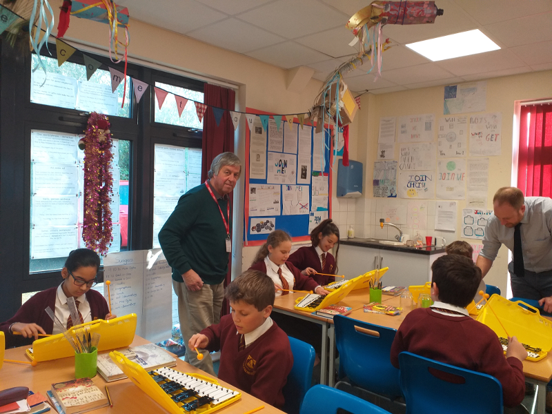Pupils from Year 6 are pictured enjoying the instruments with Trustee Gordon Clarke
