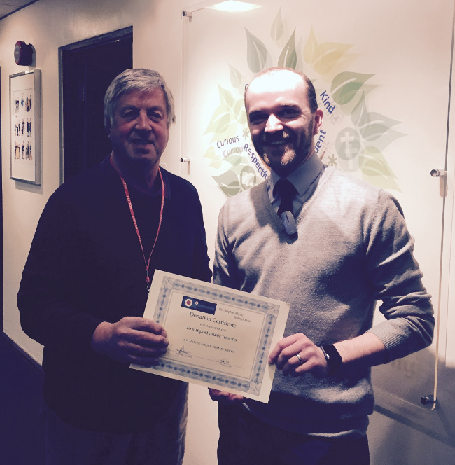 Gordon Clarke Trustee Presenting a certificate at the school.